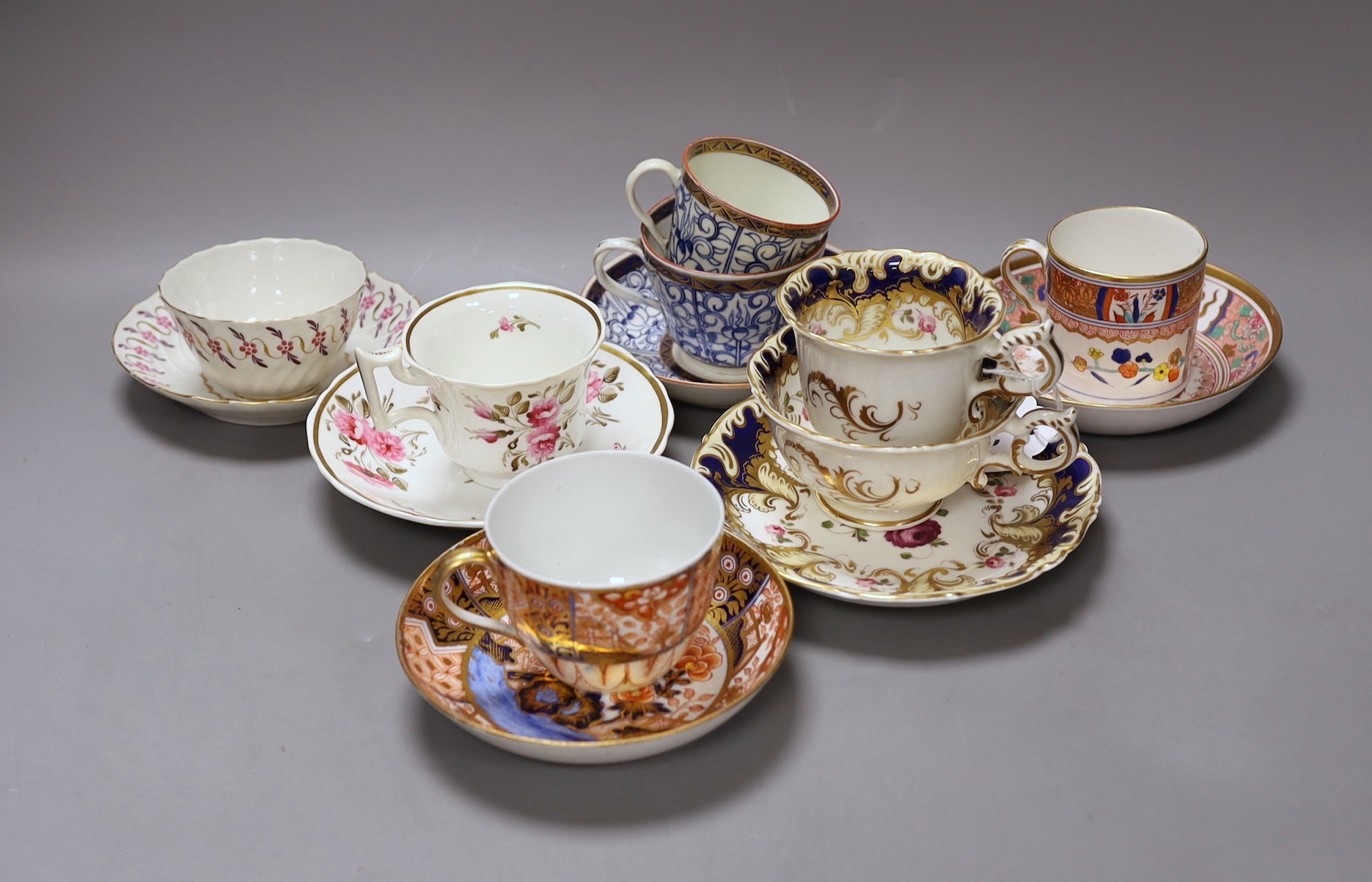 A Spode Imari pattern coffee can and saucer, a Coalport Imari cup and saucer, a Coalport style floral trio, a Worcester Royal Lily trio, a Flight teabowl and saucer and an English rose painted cup and saucer